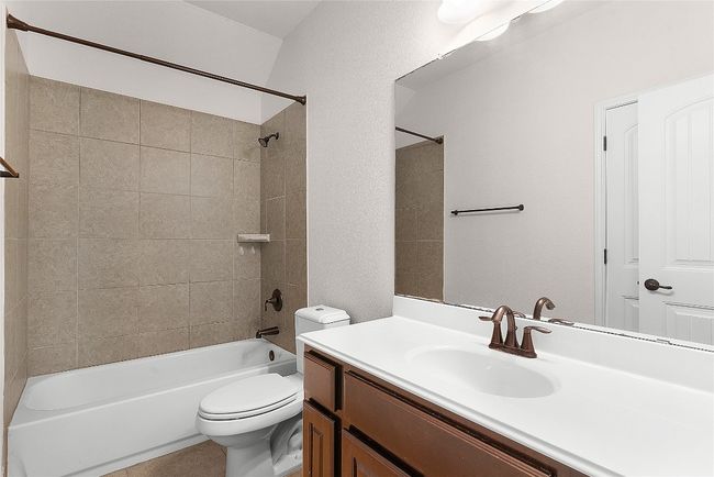 Bathroom with bathtub / shower combination, toilet, and vanity | Image 10