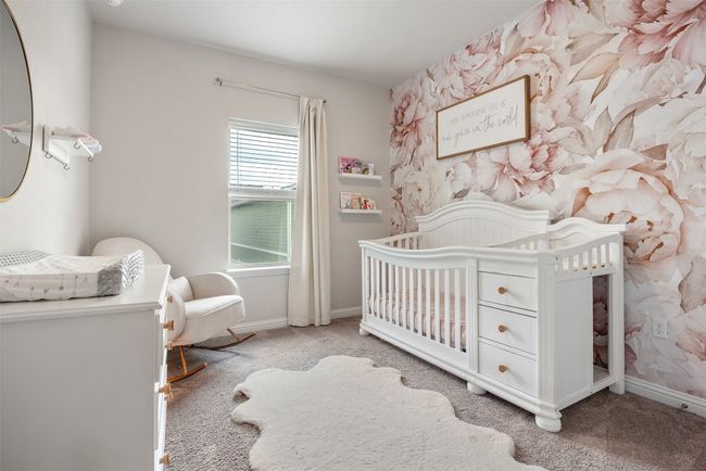 Carpeted bedroom featuring a crib and baseboards | Image 14