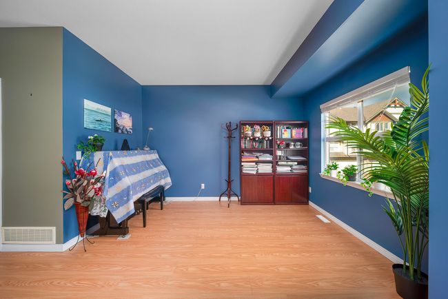 Sitting room with baseboards, wood finished floors, and visible vents | Image 23