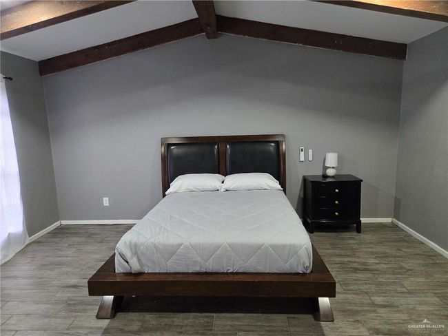 Bedroom with baseboards and wood finished floors | Image 12