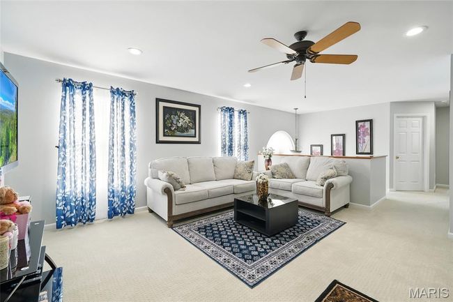 Carpeted living area featuring ceiling fan and recessed lighting | Image 10