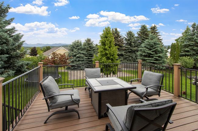 Deck with a mountain view and a yard | Image 54