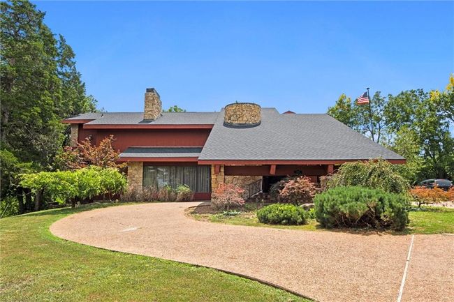 View of front facade with stone siding, a chimney, and a front yard | Image 21