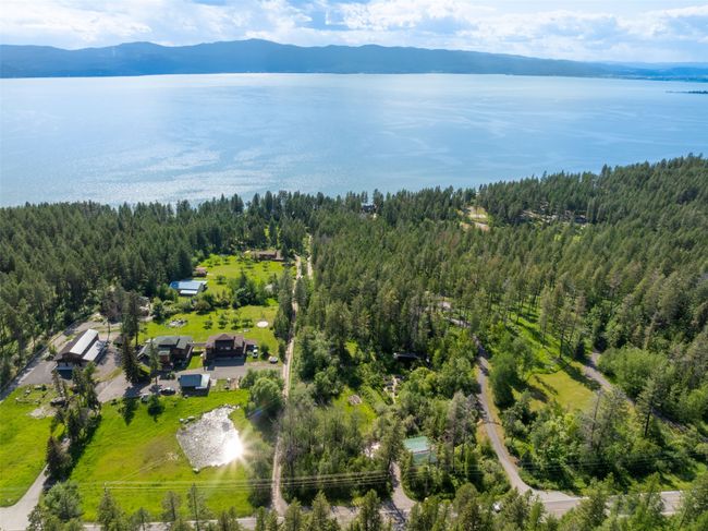 Aerial view of a heavily wooded area and a water and mountain view | Image 78