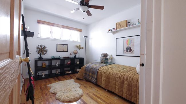 Bedroom with wood finished floors and a ceiling fan | Image 13