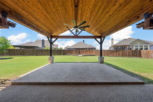 Fenced backyard with a patio and a ceiling fan | Image 30