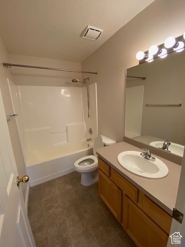 Full bathroom featuring visible vents, toilet, vanity, and shower / bathtub combination | Image 12