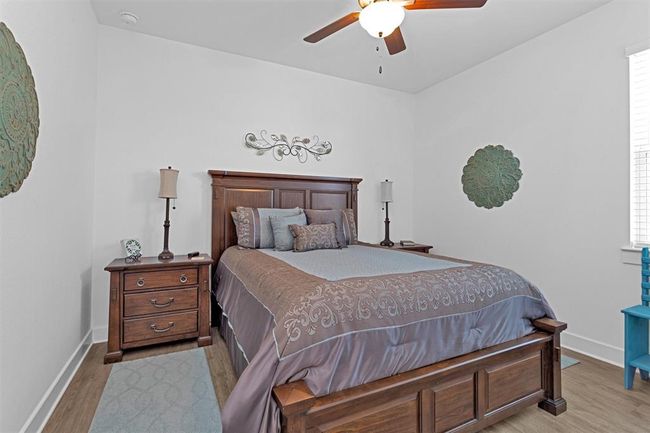 Another well-appointed bedroom with generous closet space and natural light, ready to suit your needs. | Image 34