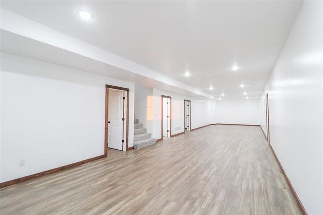 Basement with light hardwood / wood-style floors | Image 35