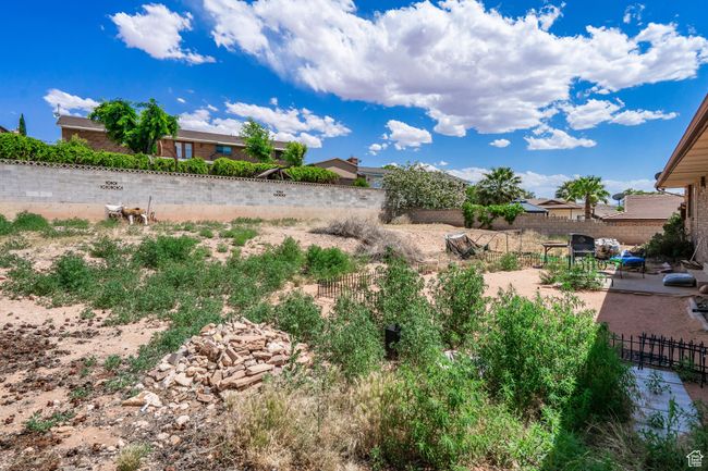 Fenced yard with a patio | Image 53