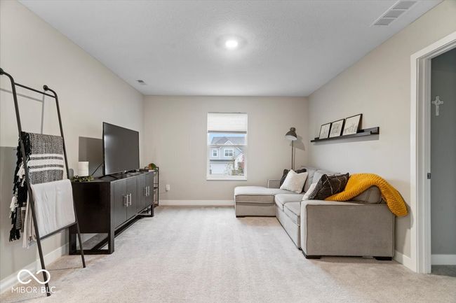 carpeted living area featuring baseboards | Image 30