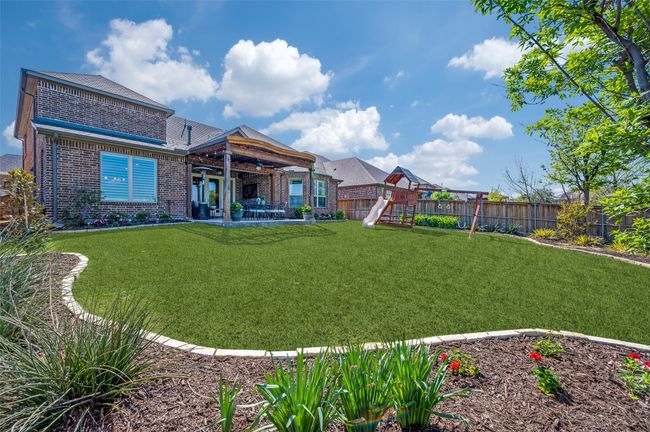 Stone edging and professional landscaping really enhance this back yard. | Image 34