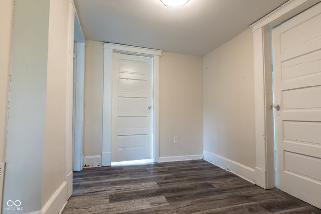 unfurnished bedroom featuring dark wood-type flooring and baseboards | Image 25