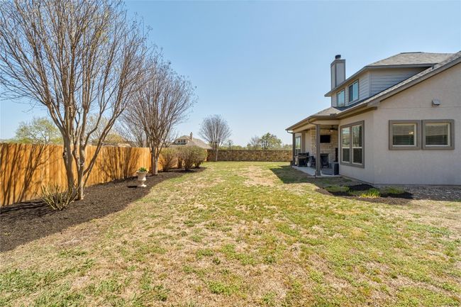 View of yard with a patio, a fenced backyard, and a ceiling fan | Image 32