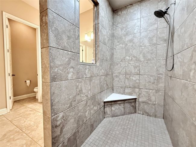 Bathroom featuring a tile shower and tile patterned flooring | Image 32