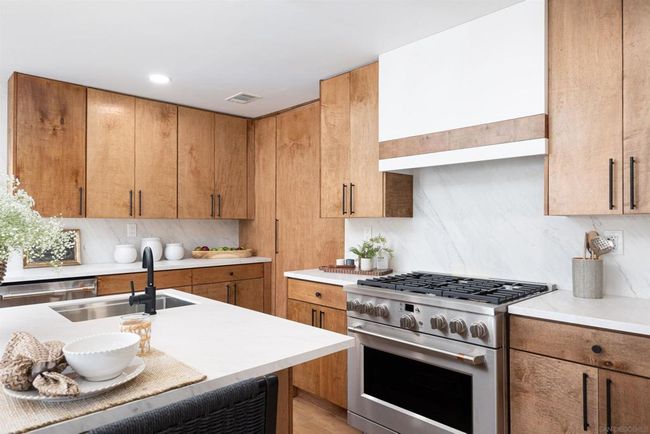 Custom hand built cabinets and porcelain backsplash along with upgraded appliances are the highlights of this kitchen | Image 15