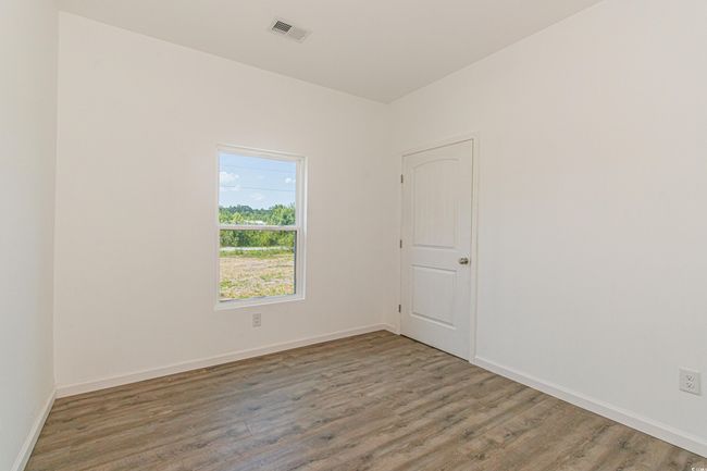 Unfurnished room featuring wood finished floors and baseboards | Image 25