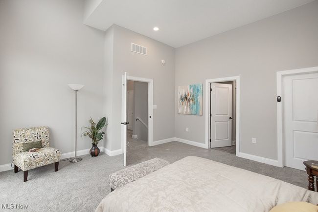 Bedroom featuring a towering ceiling and carpet | Image 27
