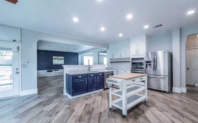 Unfurnished living room featuring ceiling fan | Image 4