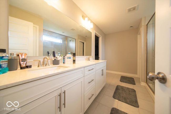full bath featuring a stall shower, double vanity, and tile patterned floors | Image 18