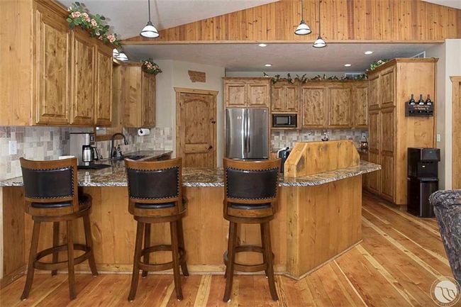 Knotty Alder cabinetry and granite counter tops | Image 7