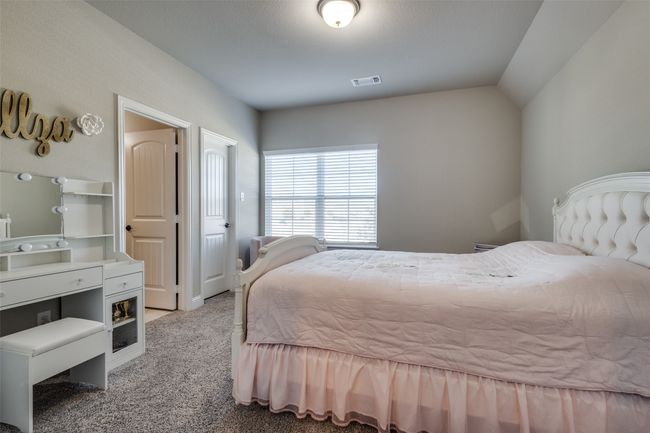 Carpeted bedroom with lofted ceiling | Image 33