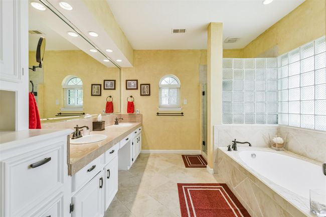 Updated Primary Bath with double sinks, vanity area, garden tub, separate shower, private water room | Image 25