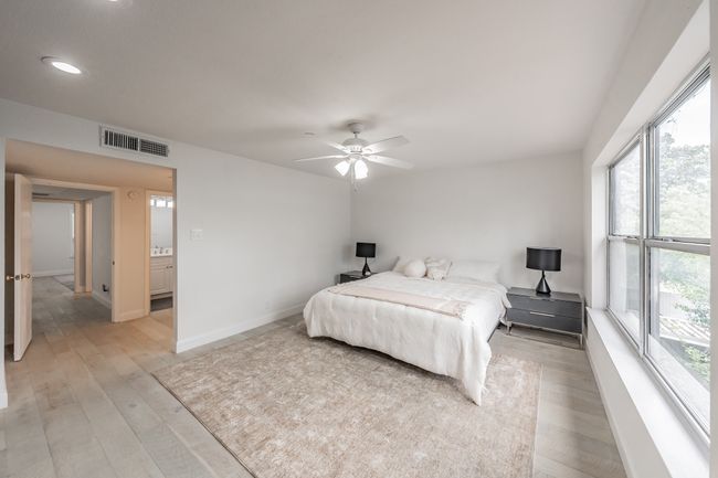 Bedroom with recessed lighting, visible vents, light wood-style floors, baseboards, and ceiling fan | Image 14