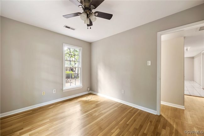 First floor bedroom featuring light wood-type flooring and ceiling fan | Image 14