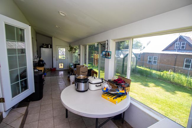 Sunroom / solarium featuring lofted ceiling | Image 21