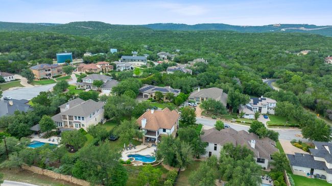Aerial view of residential area with a mountain backdrop and a forest | Image 19