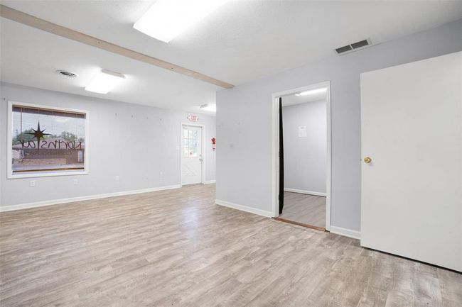 Dining space with picture window overlooking parking lot | Image 5