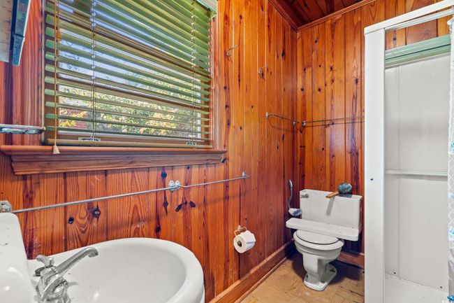 Half bathroom featuring toilet and wooden walls | Image 22