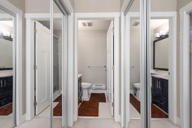 Bathroom featuring toilet, vanity, and baseboard heating | Image 23