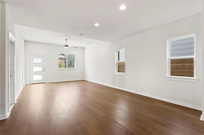Spare room with ceiling fan, dark wood-style flooring, and recessed lighting | Image 4