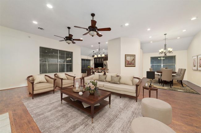 Virtually staged to highlight the open and airy layout. From this vantage point, you can fully appreciate the seamless flow and generous proportions that make this home perfect for both relaxing and entertaining. Natural light fills the room, creating an inviting ambiance that truly brings the living area to life. | Image 18