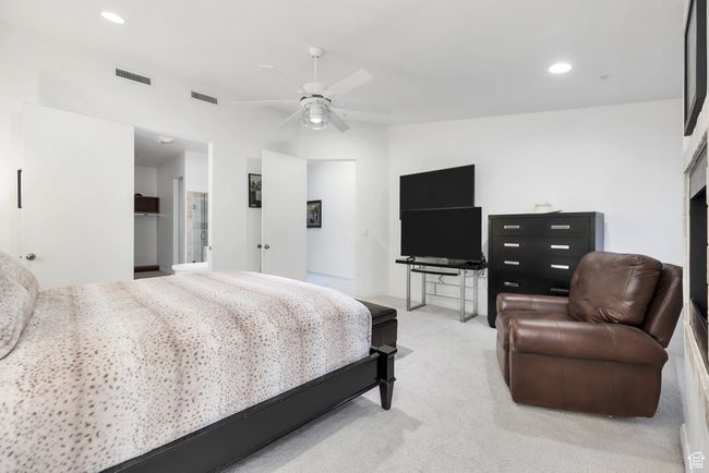Bedroom featuring recessed lighting, ceiling fan, visible vents, and light carpet | Image 20