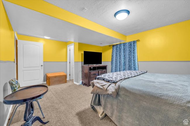 Bedroom featuring a textured ceiling and carpet floors | Image 14