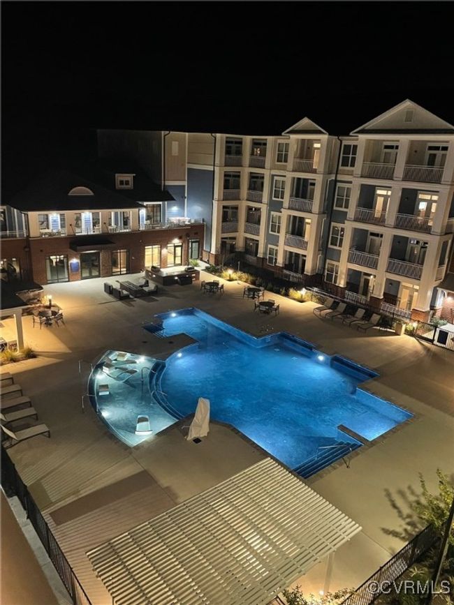 Pool at night with a community pool and a patio area | Image 20