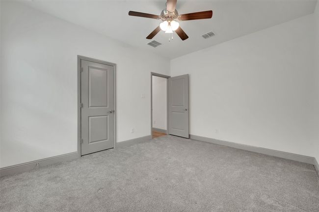 Unfurnished bedroom with visible vents, baseboards, a ceiling fan, and carpet flooring | Image 17
