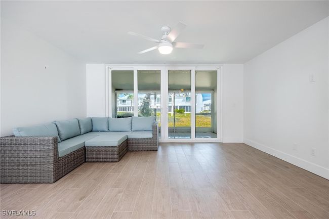 Living room with tall sliding glass doors to lanai. | Image 19