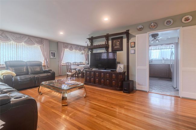 Living area featuring wood finished floors, ceiling fan, and recessed lighting | Image 4