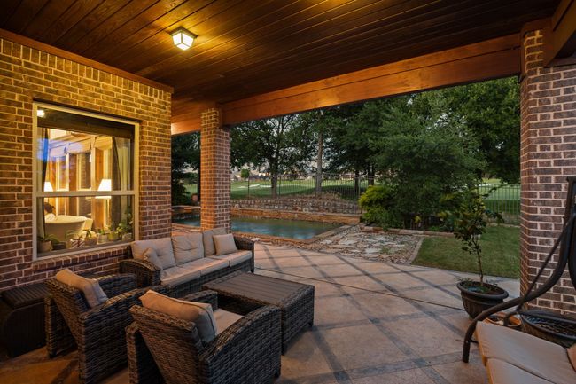 Fenced backyard with a patio | Image 33