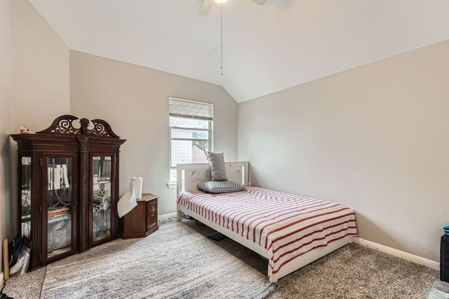 Bedroom with carpet floors, vaulted ceiling, and a ceiling fan | Image 24