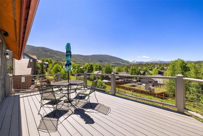 Deck with a mountain view and outdoor dining area | Image 15