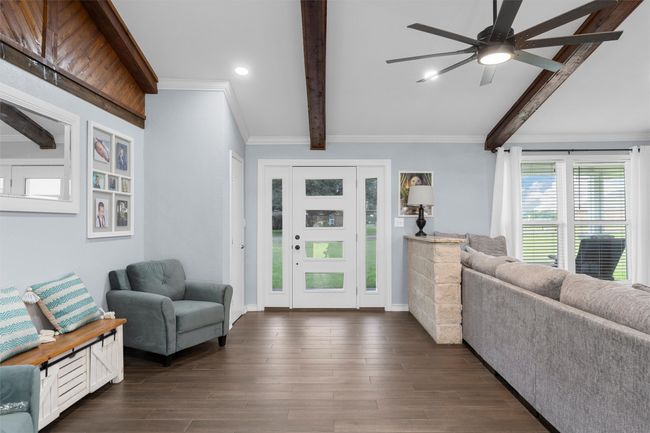 Entryway featuring beamed ceiling, a ceiling fan, recessed lighting, crown molding, and dark wood-style floors | Image 6