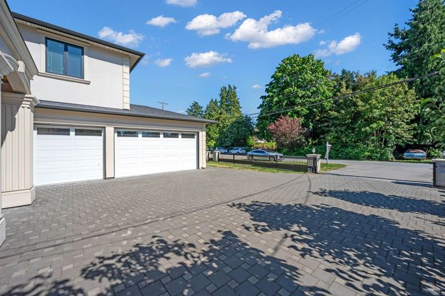 Garage with decorative driveway | Image 36