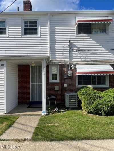 Townhome / multi-family property with central AC unit and a front lawn | Image 2