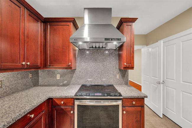 The closed door on right is the washer/dryer and hot water heater. Sellers replaced washer/dryer in 2023. To right of the closed door is Walk-In Pantry which is out of camera range. | Image 18
