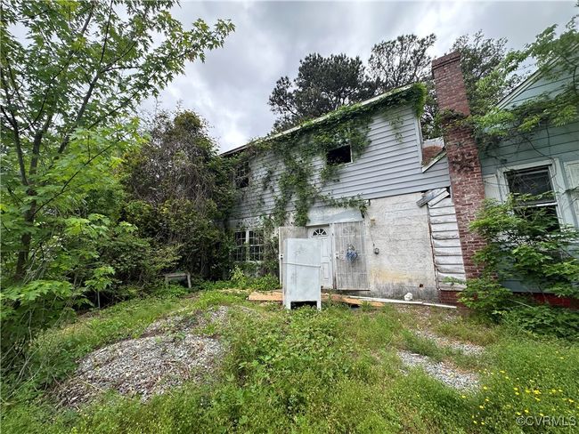 Rear view of property featuring a chimney | Image 28